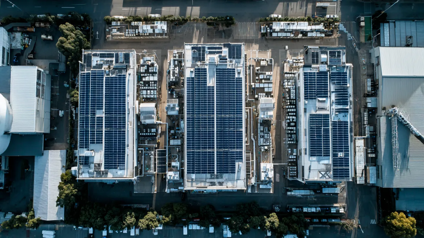 Aerial view of commercial rooftops covered in solar panels